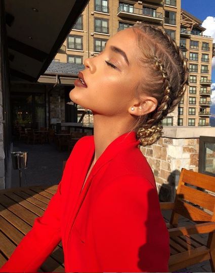 Jasmine Sanders with blonde cornrows styled in a bun