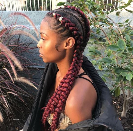 Woman with burgundy cornrow braids with hair cuffs