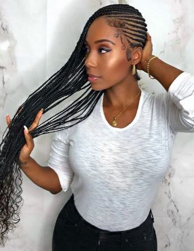 Woman with long cornrow lemonade braids