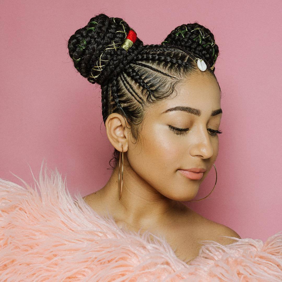 Woman with double cornrow braided buns