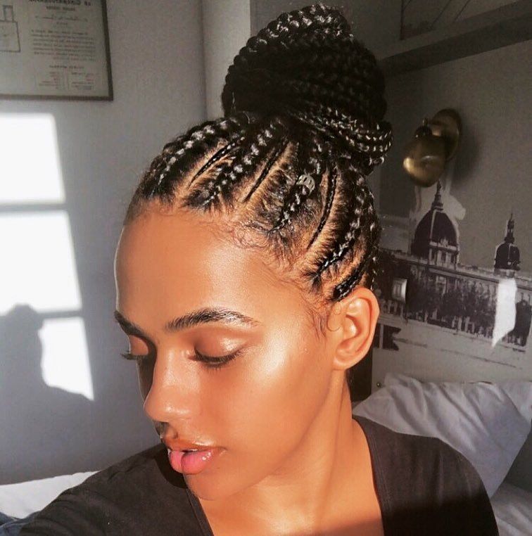 Woman with cornrows styled in an updo