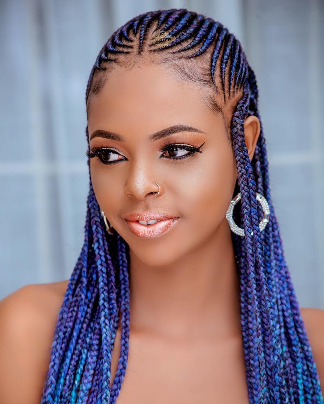 Woman with cornrows and long single plaits at the back