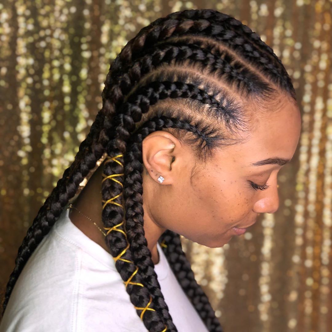 Woman with feed in cornrows with gold thread details