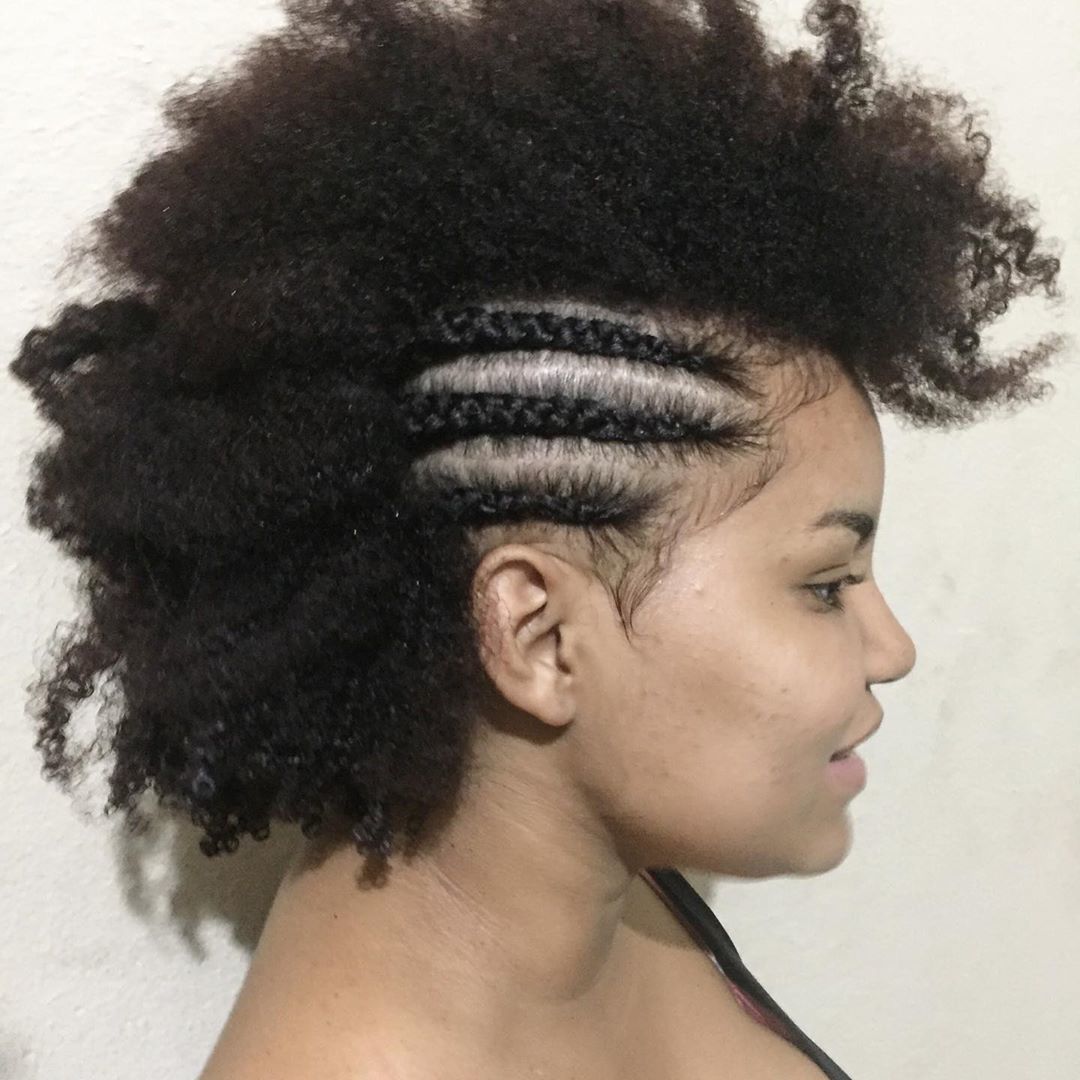 Woman with natural hair with half in cornrows