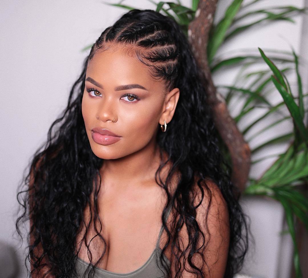Woman with half cornrows with long, wavy loose weave