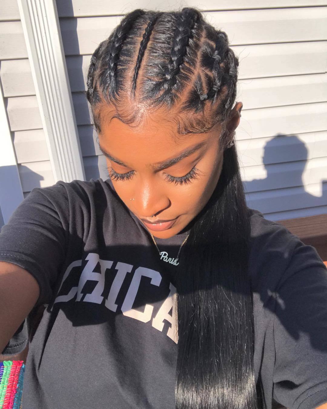 Woman with half head cornrows into a sleek long ponytail