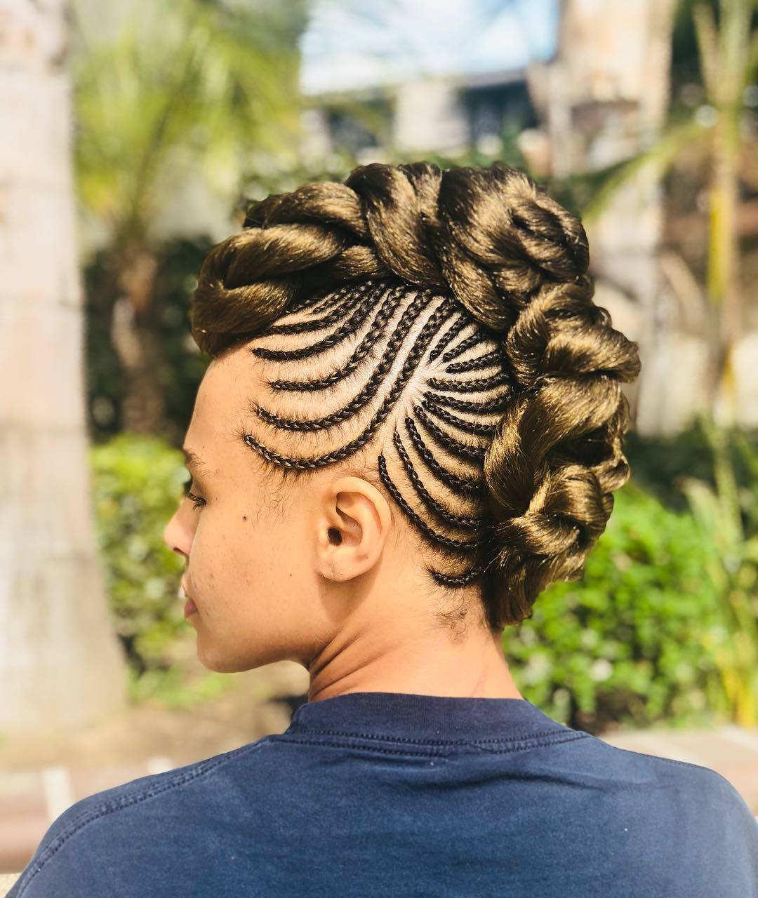 Woman with a cornrowed mohawk hairstyle