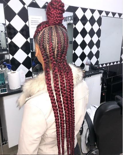 Woman with red cornrows in half-up bun