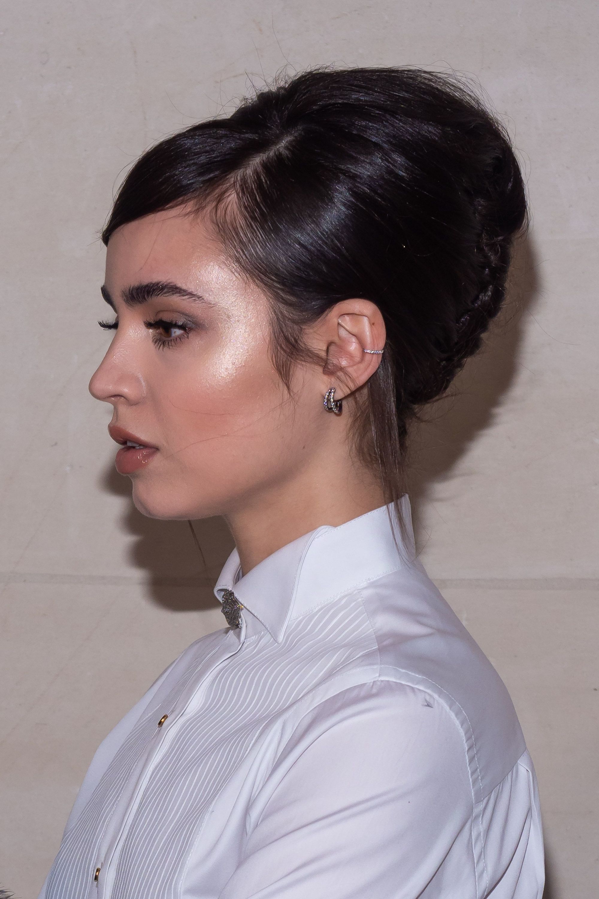 Woman with side parted bouffant bun hairstyle