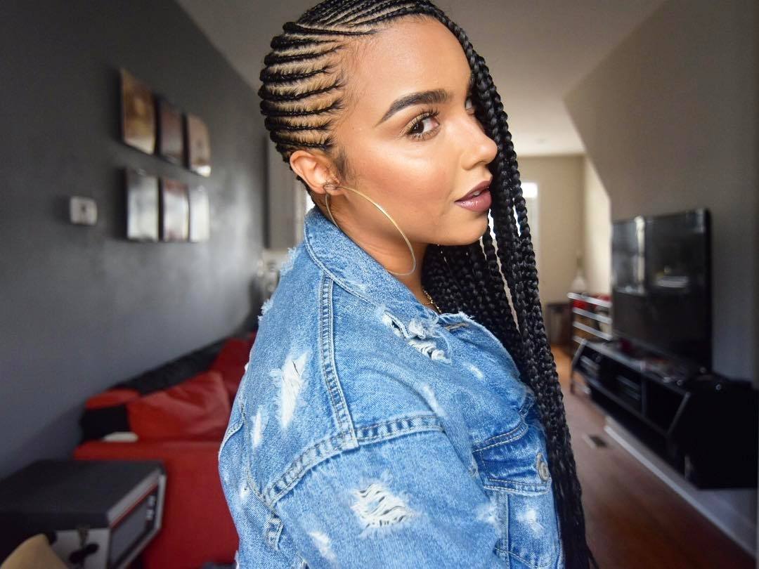 Woman with tight side swept long cornrows