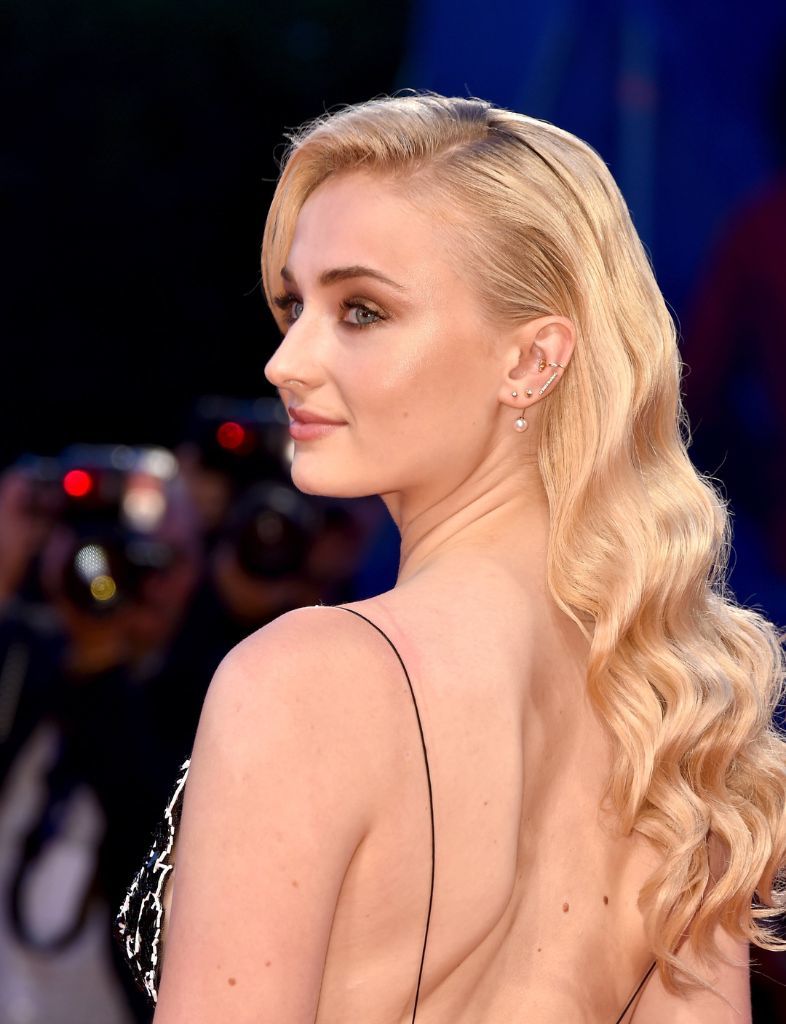 Sophie Turner at Venice Film Festival with long blonde hair.