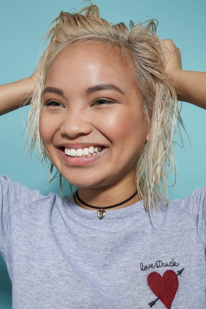 Woman with bleach blonde wet bob