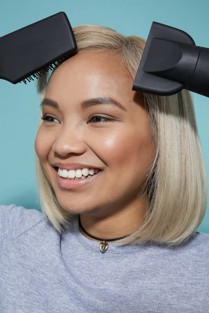 Woman blow-drying blonde bob