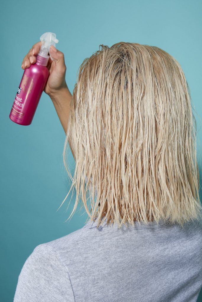 Woman with bleach blonde wet bob