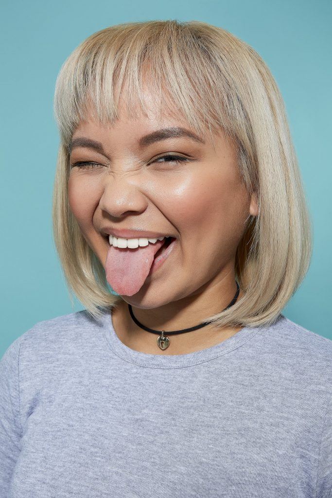 Woman with bleach blonde bob and bangs