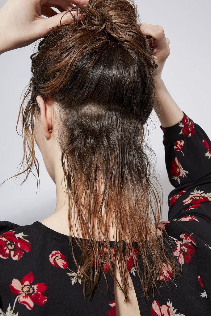 Woman with wet curly hair