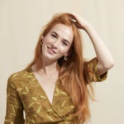 Redhead model with long hair touching her hair