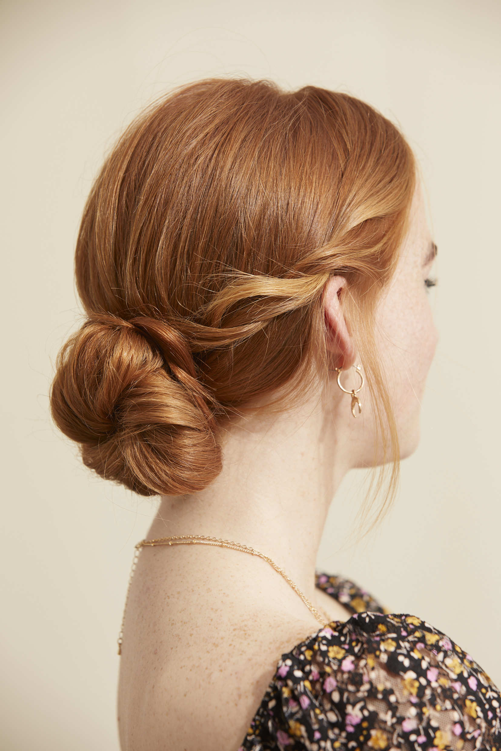 Side view of a red haired woman with a bun