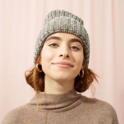 Smiling woman with beanie hat and space buns