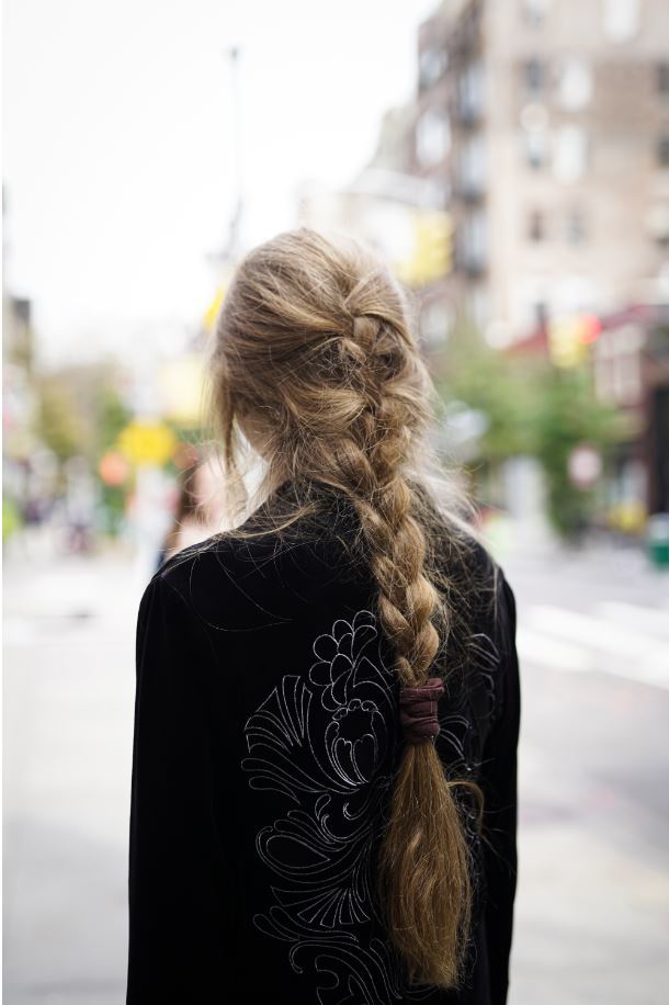 Back view of a woman with a loose French plait