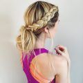Woman with blonde hair styled into a low messy bun with side braid