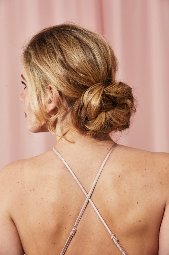 Blonde with a low loose twisted bun