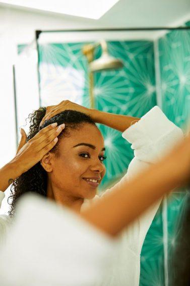 woman with naturally curly hair in bath robe