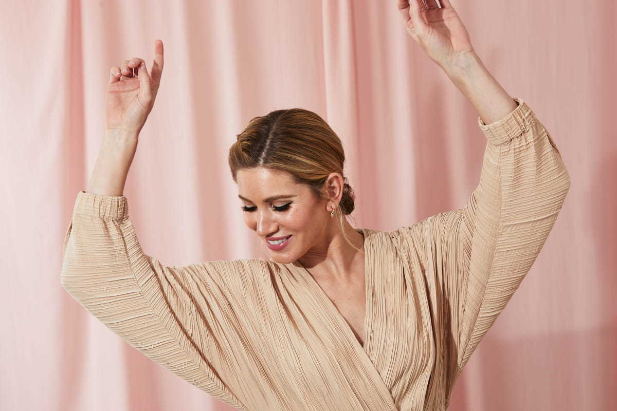 Woman dancing to music at home