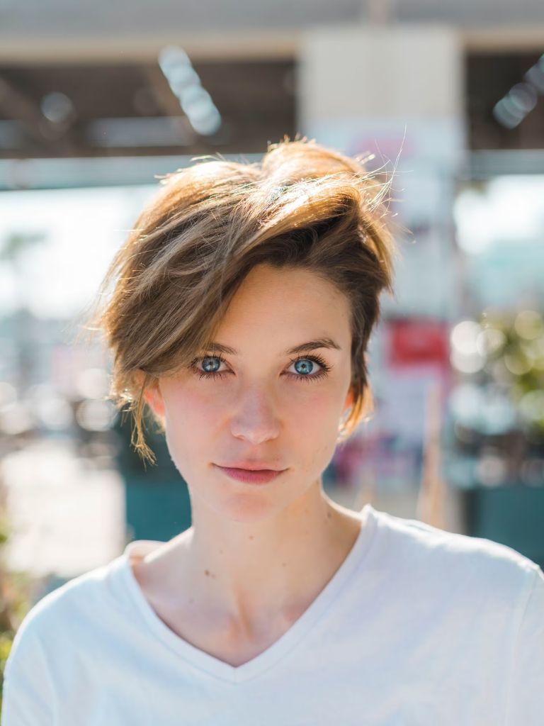 Woman with pixie cut with side-swept fringe.