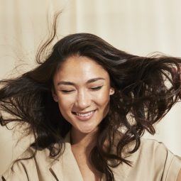 Woman with brunette long hair blowing in the wind