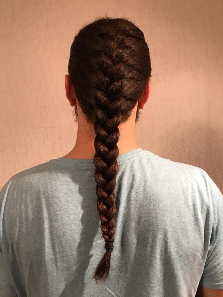 Brown haired man with a long French braid