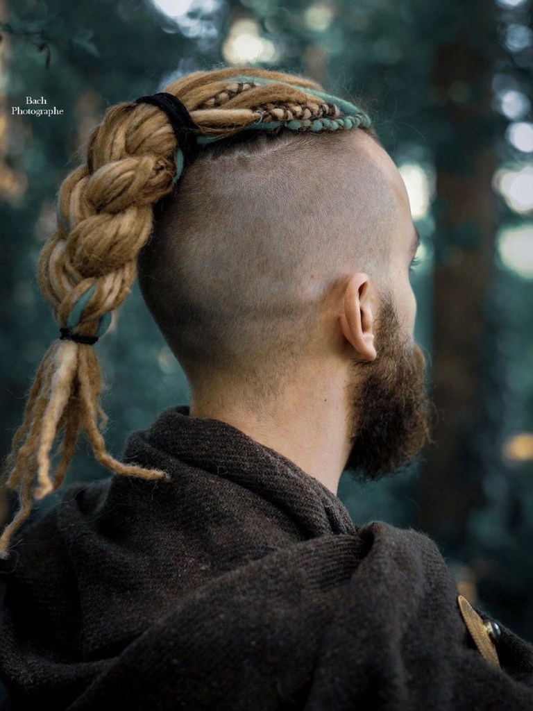 Man with blonde mohawk dreadlocks with shaved sides