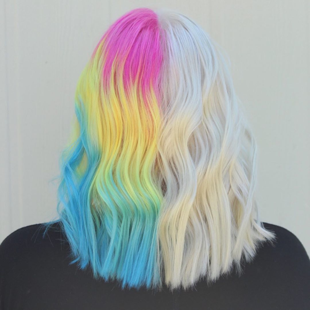 Woman with half icy blonde hair and half rainbow ombre