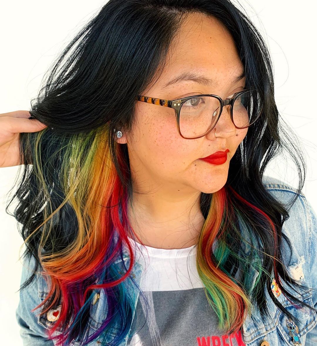 Woman with dark brown hair with hidden rainbow highlights