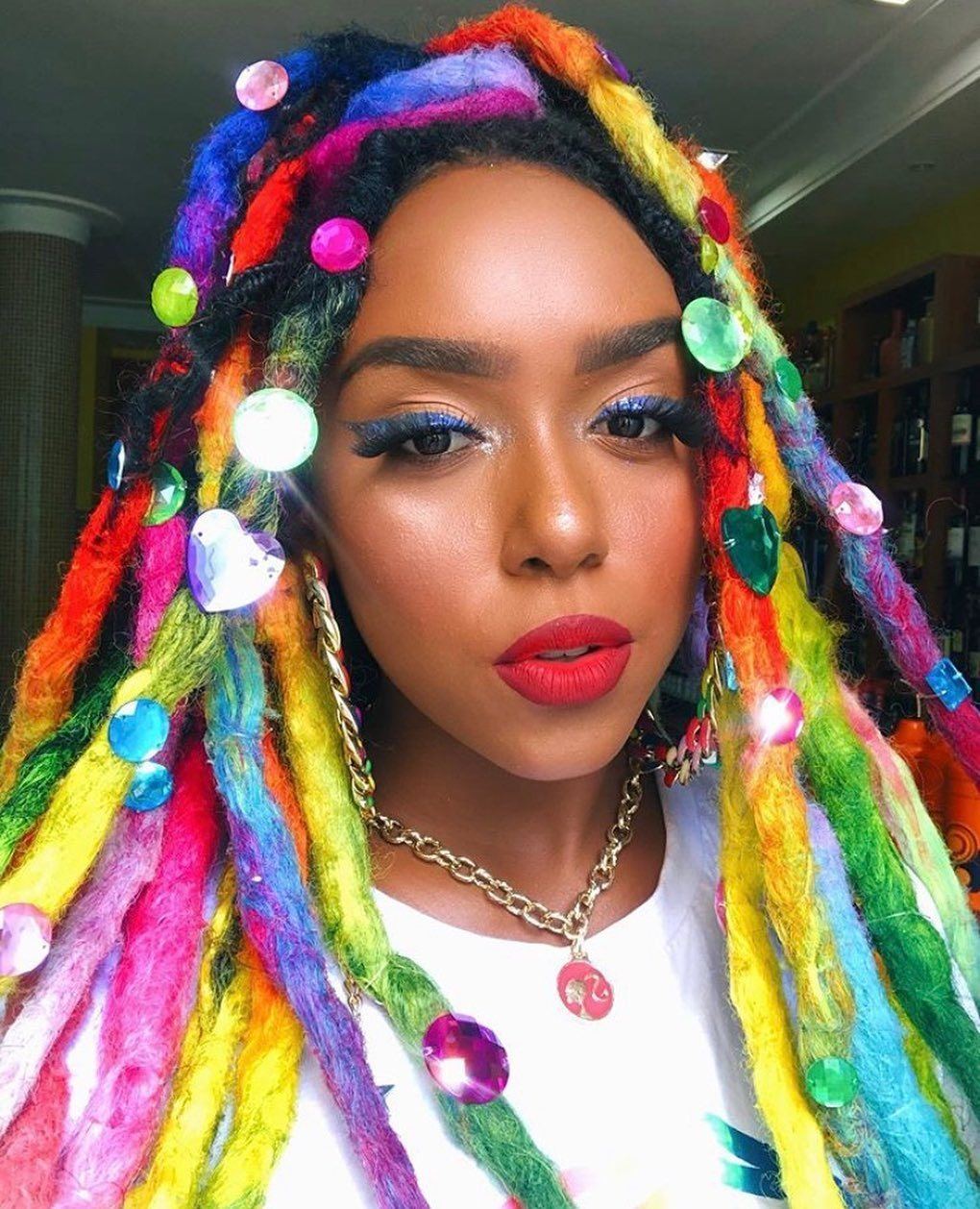 Woman with rainbow coloured locks with gems and embellishments