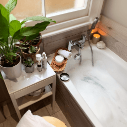 Shot of a bathtub, candle and plants