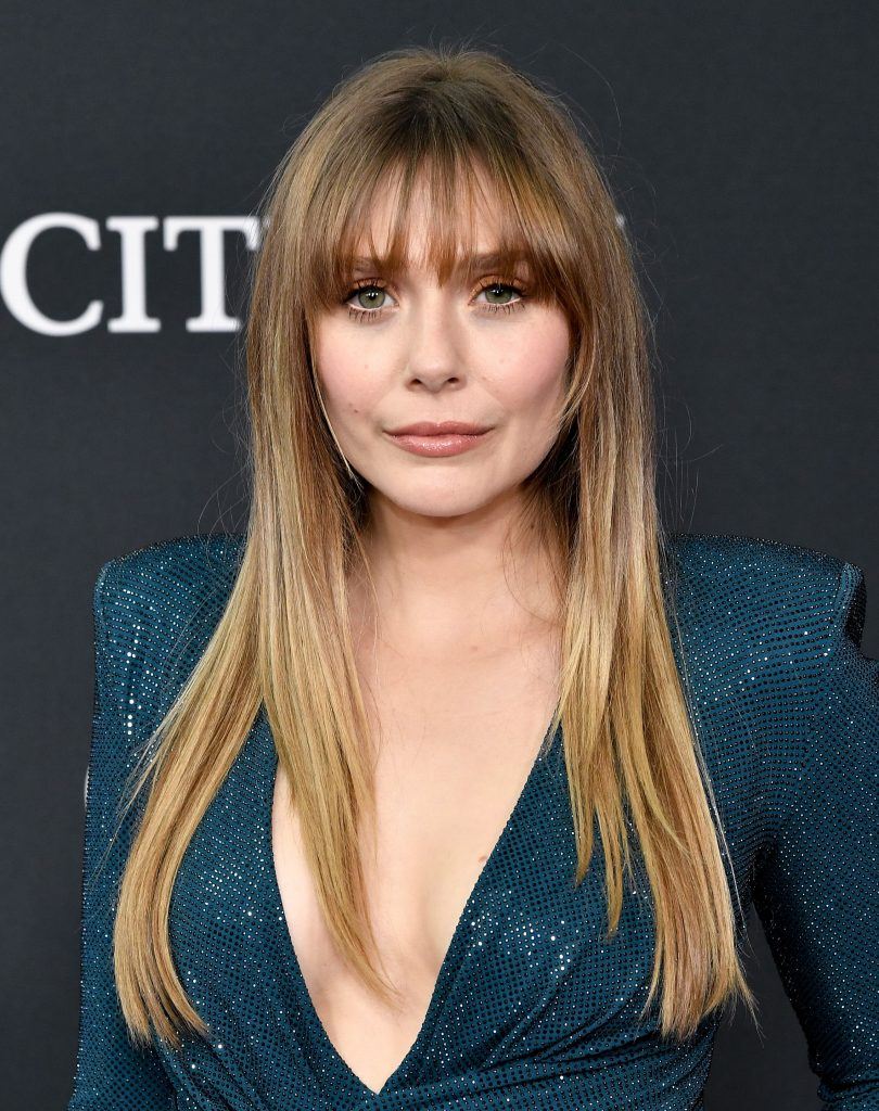 Elizabeth Olsen with long layered bronde hair with bangs