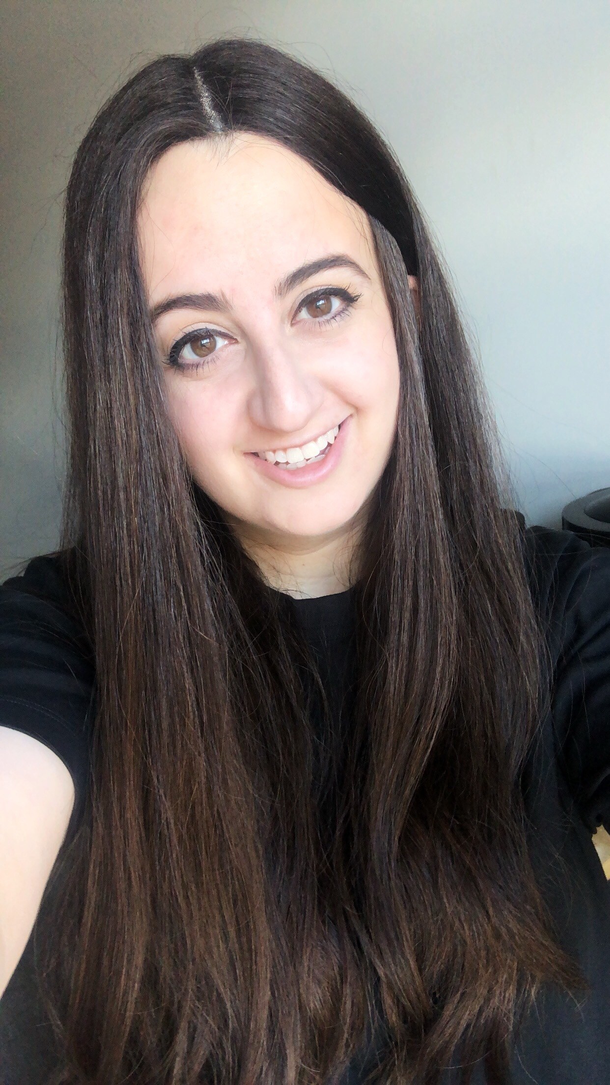 woman with long brown hair in a centre parting