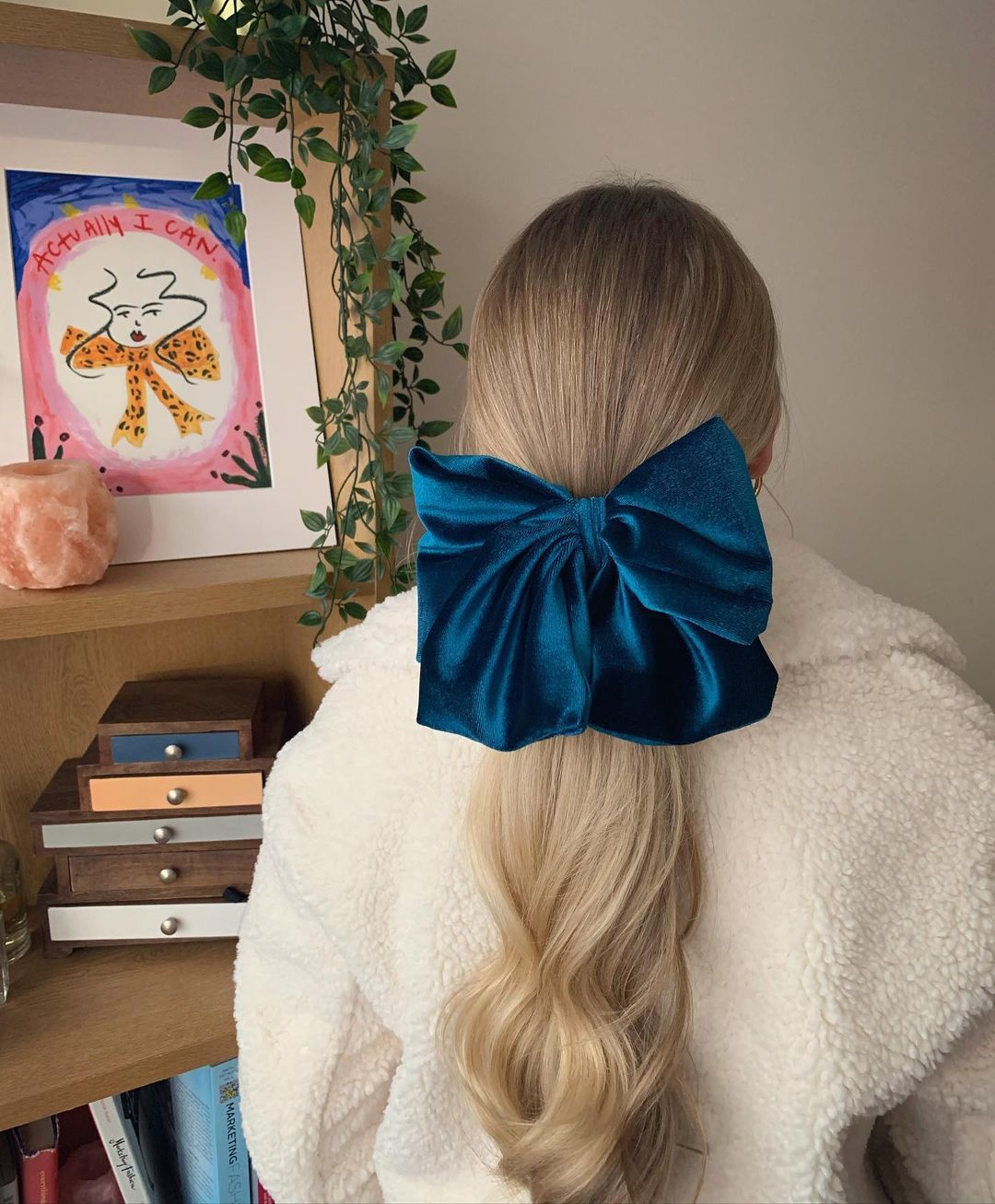 Woman with blonde ponytail and blue velvet hair bow