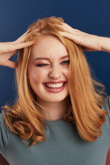 Woman touching her hair and smiling