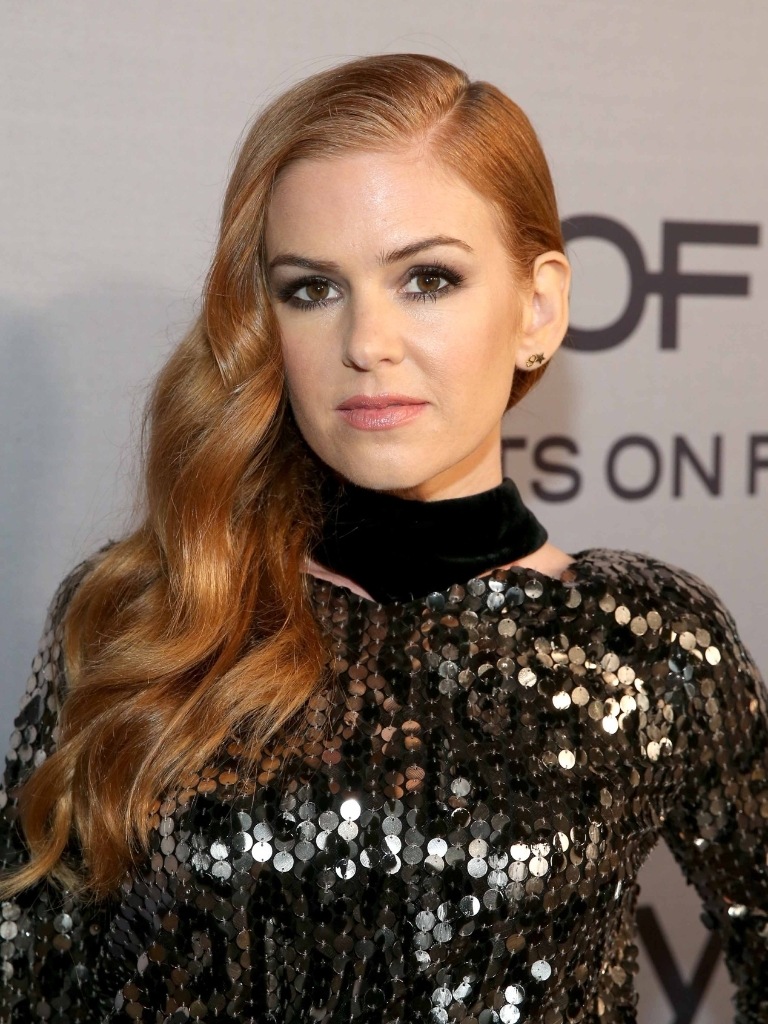 Famous redheads: Isla Fisher with long ginger hair wearing sparkly dress.