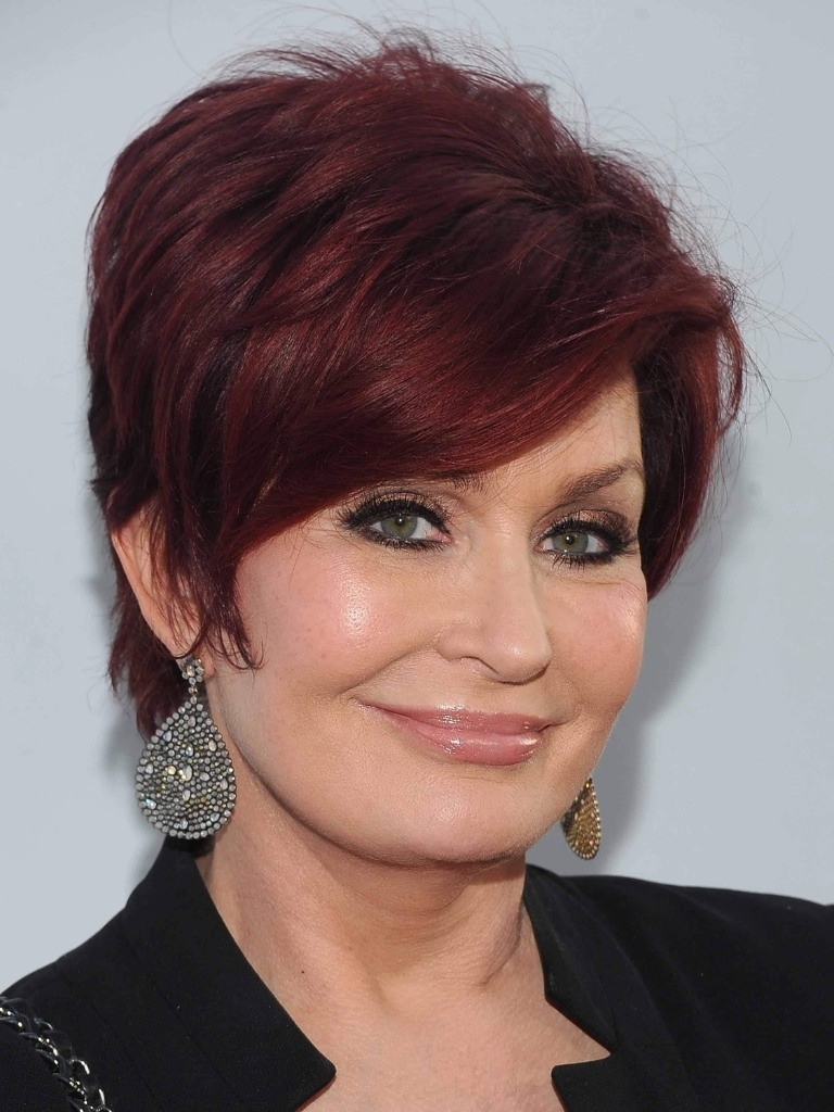 Famous redheads: Sharon Osbourne with long mahogany pixie cut wearing black.