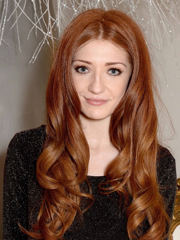 Famous redheads: Nicola Roberts with smoky red long curly hair.