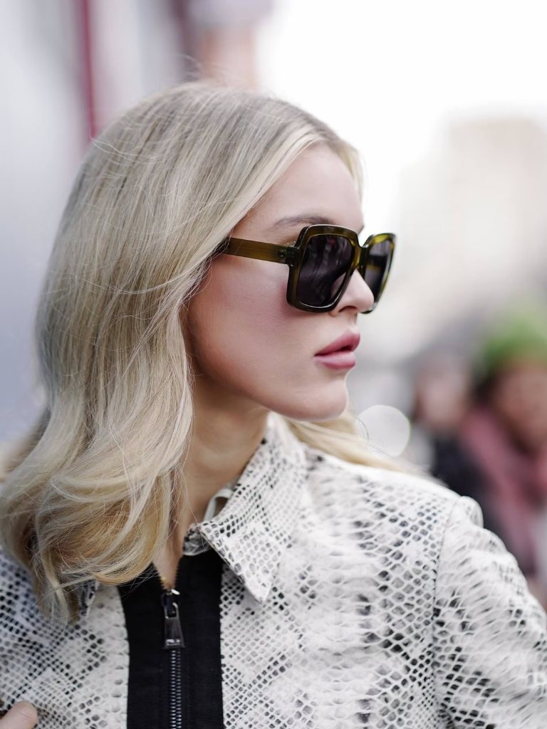Woman with mid-length wavy ice blonde hair at NYFW