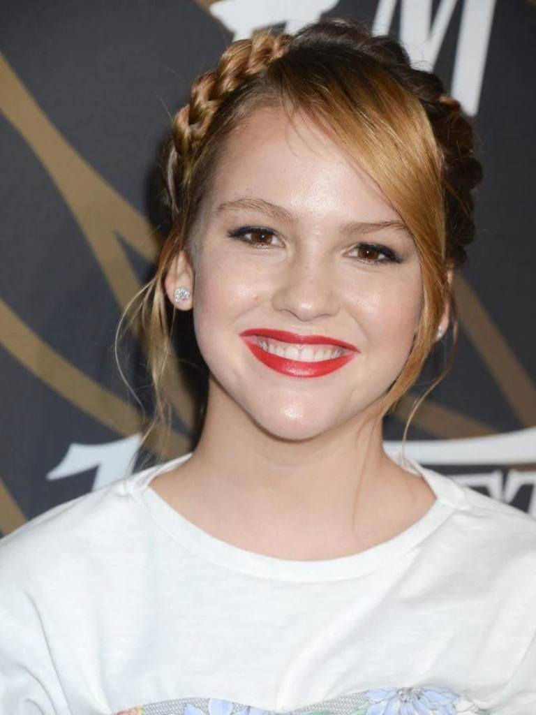 front view image of Talitha Bateman with a side swept fringe in a strawberry blonde colour