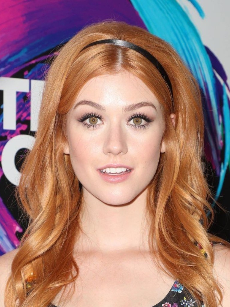 Katherine McNamara with her hair worn down in a strawberry blonde colour and wearing a headband