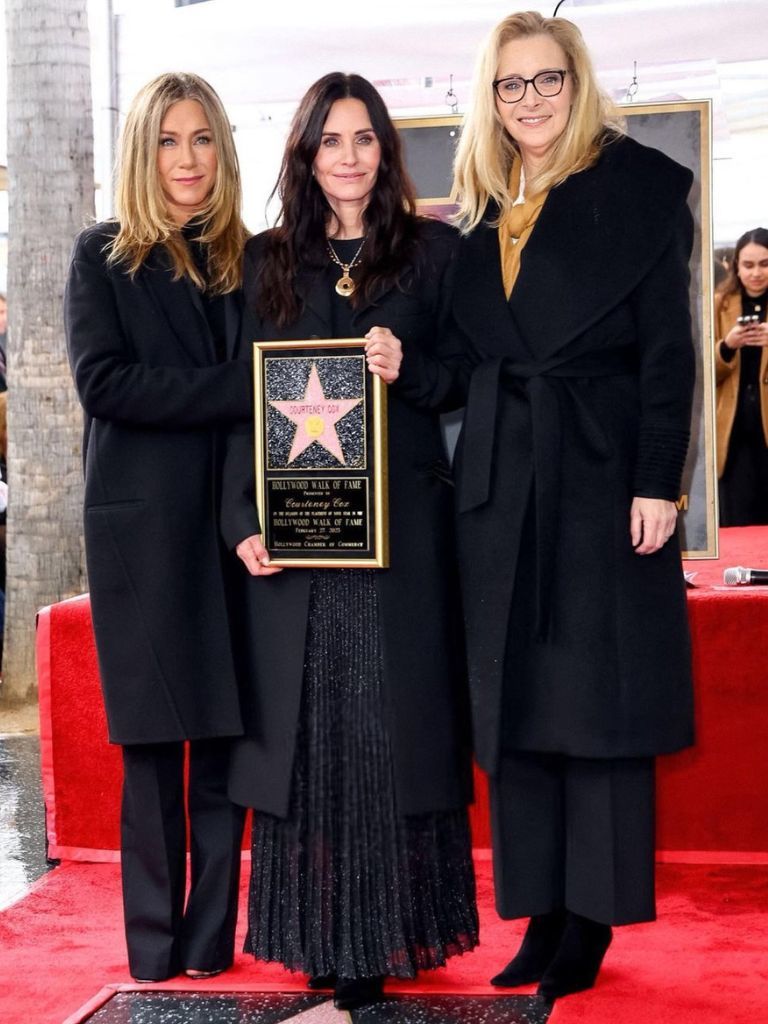 Jennifer Aniston, Lisa Kudrow and Courtney Cox holding a Hollywood Walk Of Fame Star.