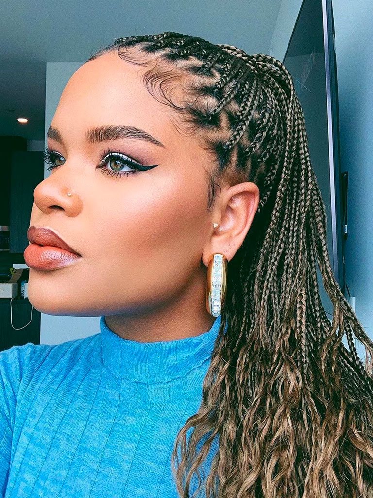 Woman with knotless golden ponytail hairstyle with wavy ends