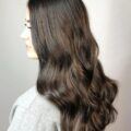 Woman with a subtle balayage on dark brown hair
