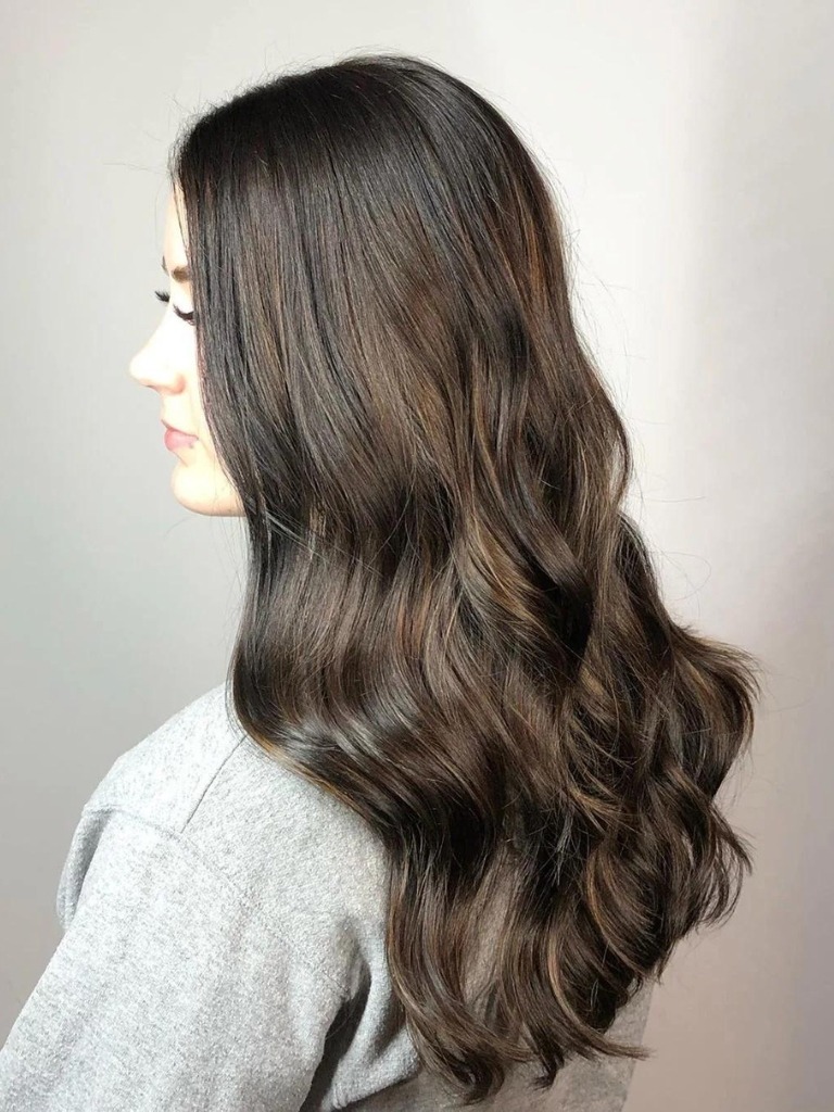 Woman with a subtle balayage on dark brown hair
